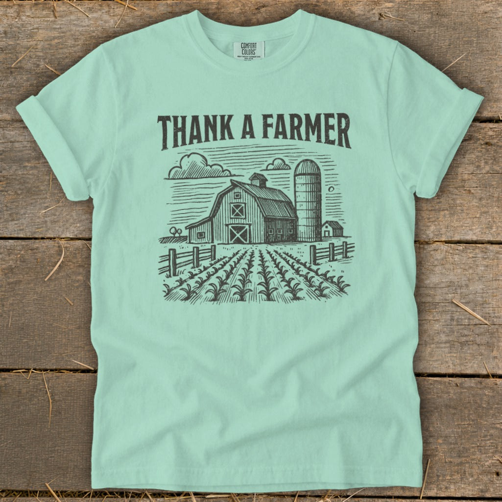 Mint green t-shirt with "THANK A FARMER" and farm scene graphic.