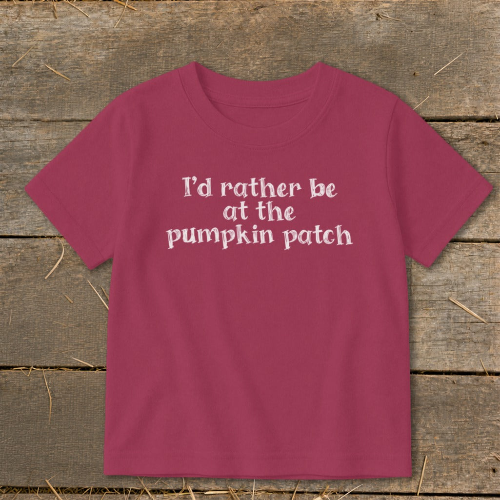 Pink t-shirt with white text "I'd rather be at the pumpkin patch".