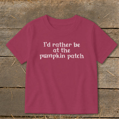 Pink t-shirt with white text "I'd rather be at the pumpkin patch".