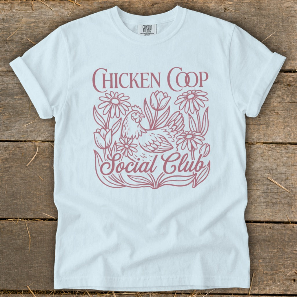 White t-shirt with "CHICKEN COOP SOCIAL CLUB" text and chicken with flowers design.