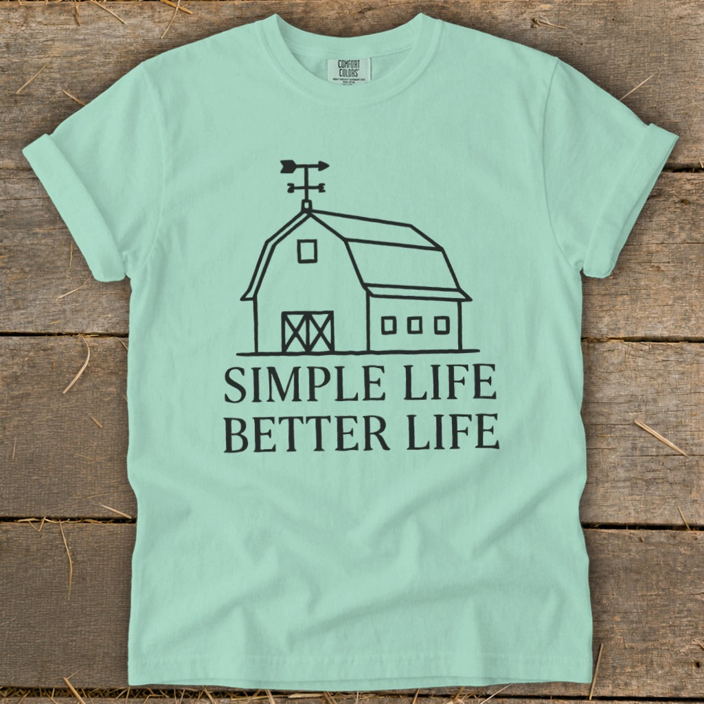 Mint green t-shirt with a black line drawing of a barn and the text "SIMPLE LIFE BETTER LIFE".