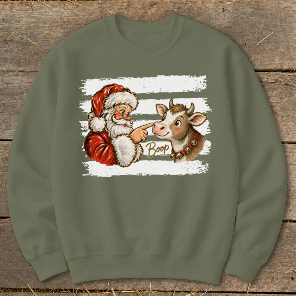 Santa booping a cow's nose with "Boop" text on a sweatshirt.