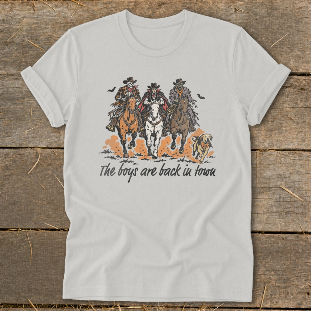 White t-shirt graphic of three skeleton figures on horses with a dog running behind.