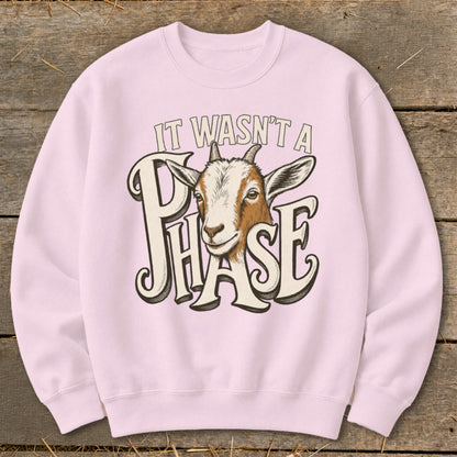 Pink sweatshirt with a goat and "It Wasn't A Phase" text graphic.