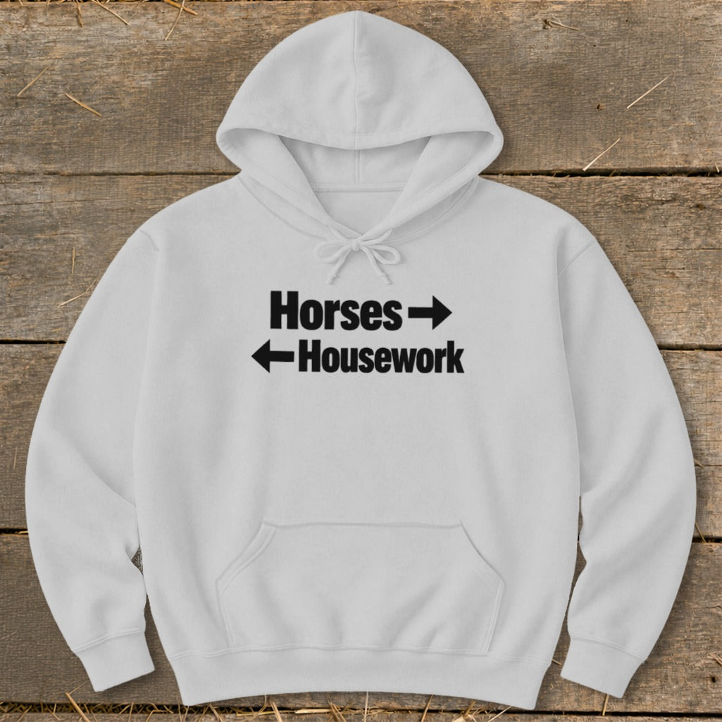 A light gray hooded sweatshirt with black text reading Horses and Housework, featuring directional arrows.