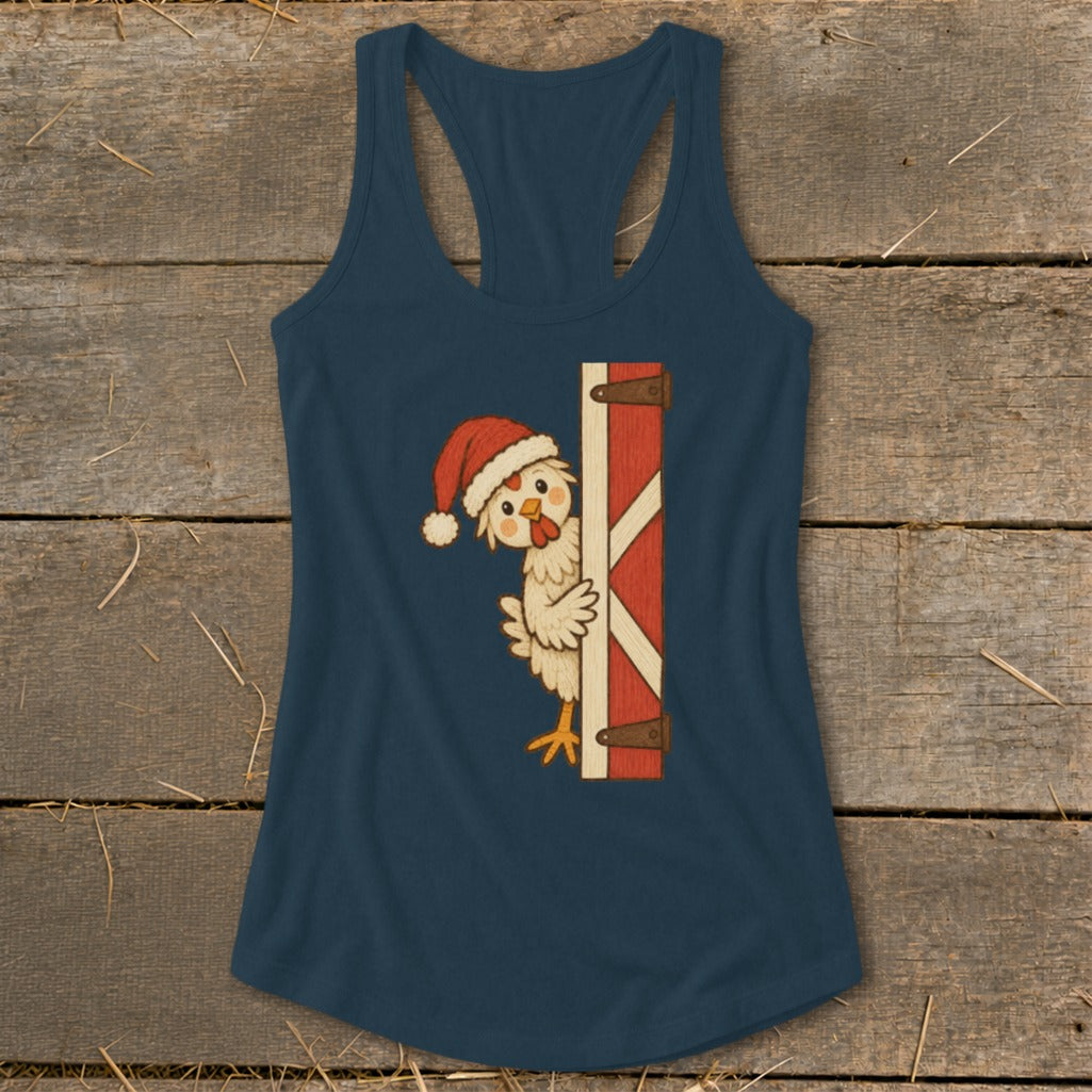 Christmas chicken in Santa hat peeking from a barn door on a dark blue tank top.