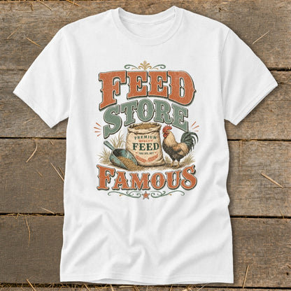 White t-shirt with "Feed Store Famous" text, a bag of feed, rooster, and shovel graphic.