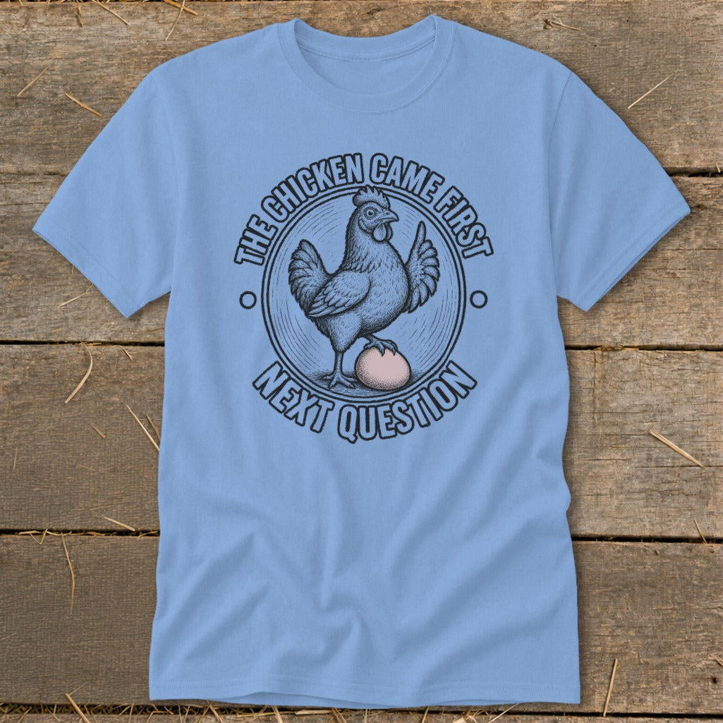 Light blue t-shirt with a chicken and egg graphic and text.