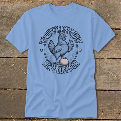 Light blue t-shirt with a chicken and egg graphic and text.
