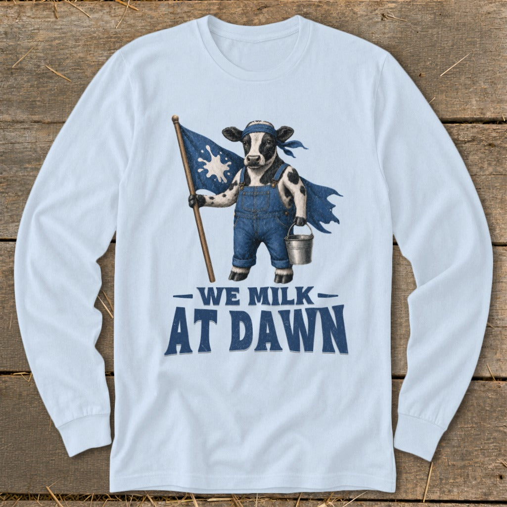 Cow wearing overalls and cape holding flag with "WE MILK AT DAWN" text.
