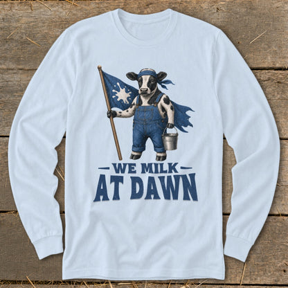 Cow wearing overalls and cape holding flag with "WE MILK AT DAWN" text.
