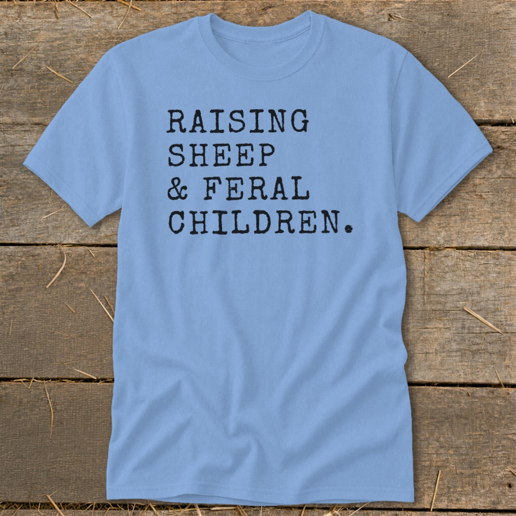 Light blue t-shirt with black text: Raising Sheep & Feral Children.