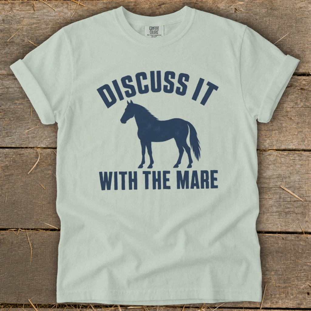 Light blue t-shirt with navy blue text and horse graphic: "DISCUSS IT WITH THE MARE".