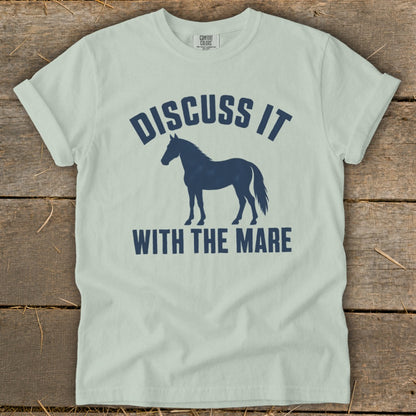 Light blue t-shirt with navy blue text and horse graphic: "DISCUSS IT WITH THE MARE".