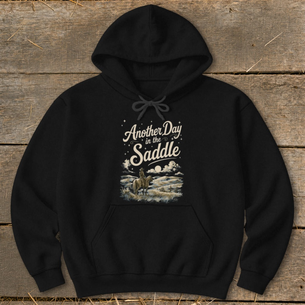 Black hoodie with "Another Day in the Saddle" text and rider on horseback graphic.