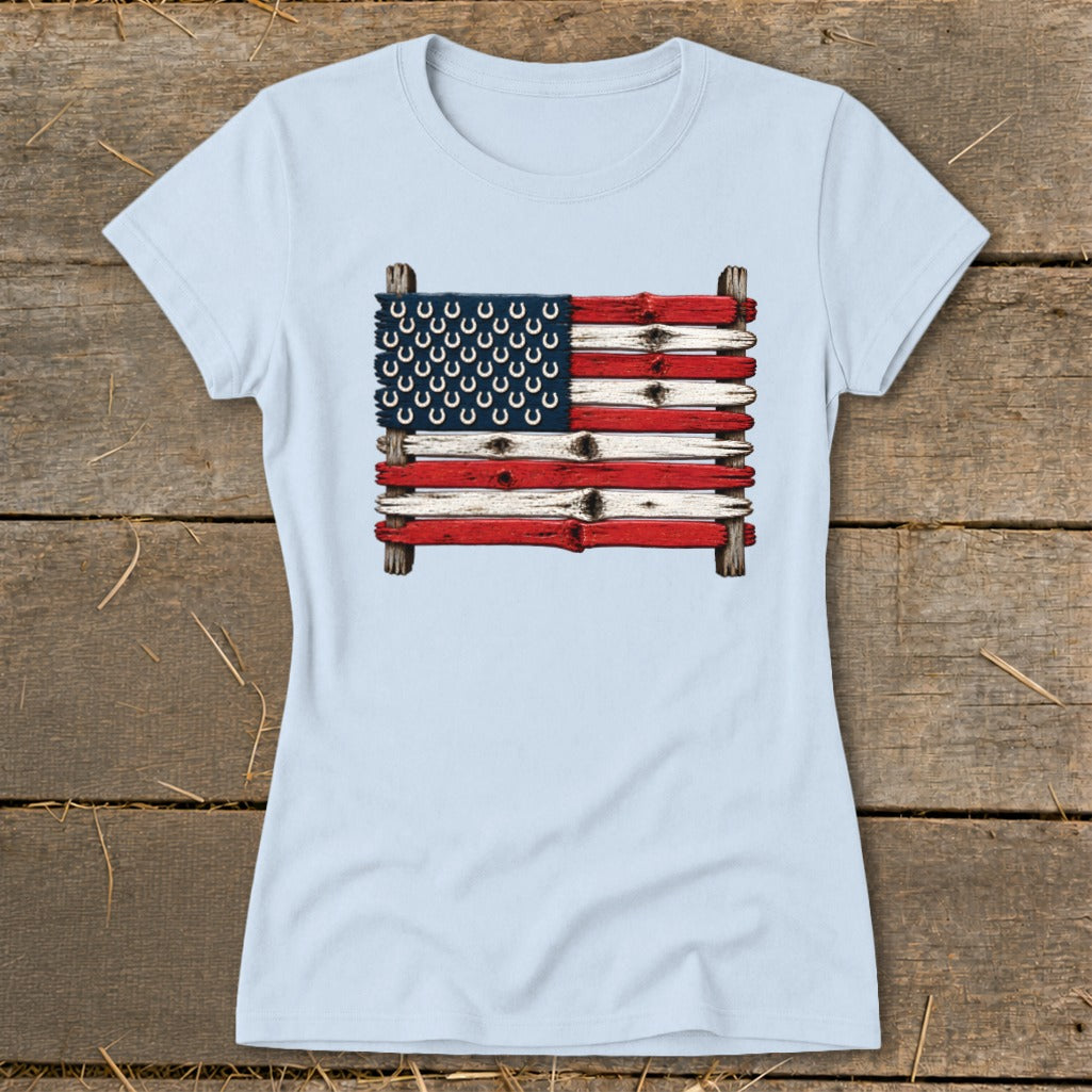 Light blue crewneck t-shirt featuring a graphic of the American flag made from weathered wooden planks and horseshoes.