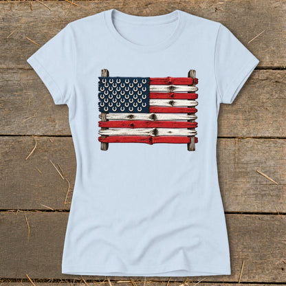 Light blue crewneck t-shirt featuring a graphic of the American flag made from weathered wooden planks and horseshoes.