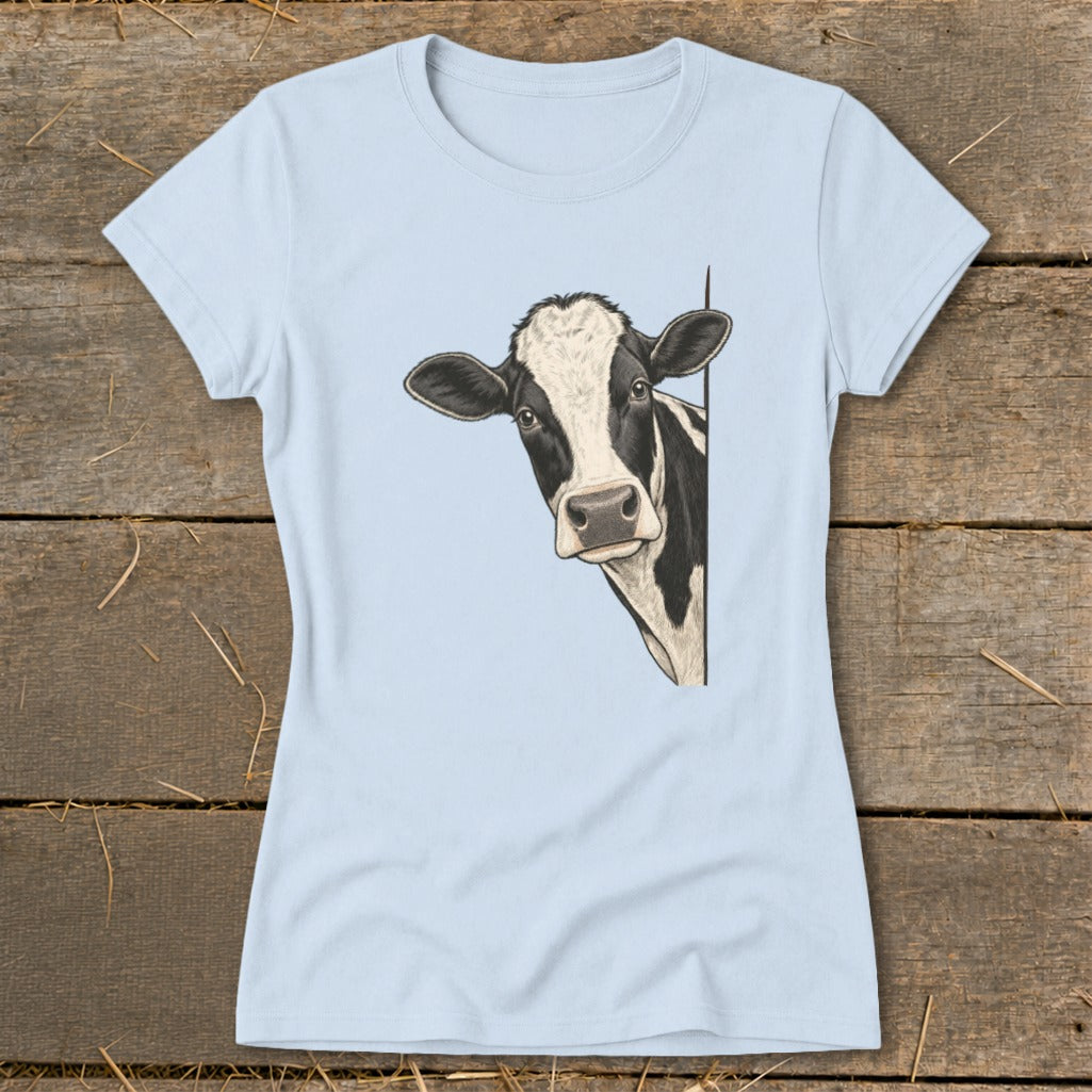Light blue t-shirt with a black and white cow peeking from the side.