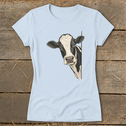 Light blue t-shirt with a black and white cow peeking from the side.