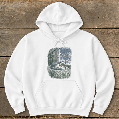 White hoodie featuring a cat sleeping on hay in front of a snowy window view.