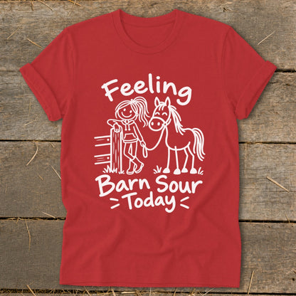 Red t-shirt with white text and drawing of a girl and horse saying "Feeling Barn Sour Today."