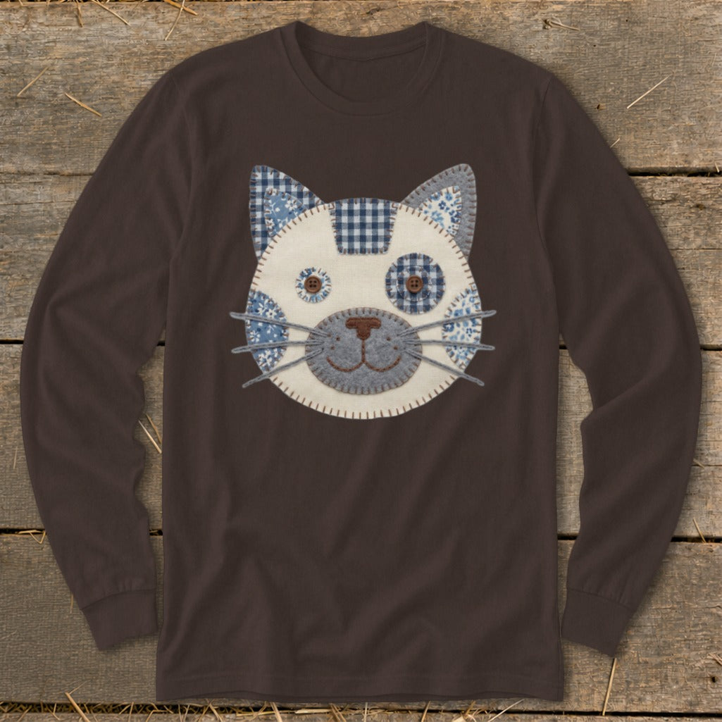 Brown long-sleeved shirt with a fabric cat face applique.