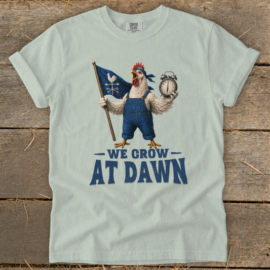 Chicken in overalls holding flag and alarm clock, "We Grow At Dawn" text.