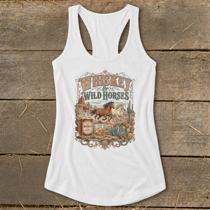 White tank top with "Whiskey & Wild Horses" desert graphic featuring horses, whiskey bottle, and cacti.