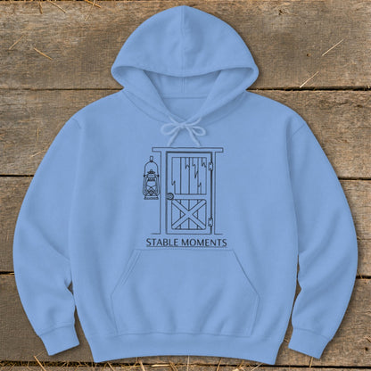 Light blue hoodie with barn door and lantern line art, text "STABLE MOMENTS".