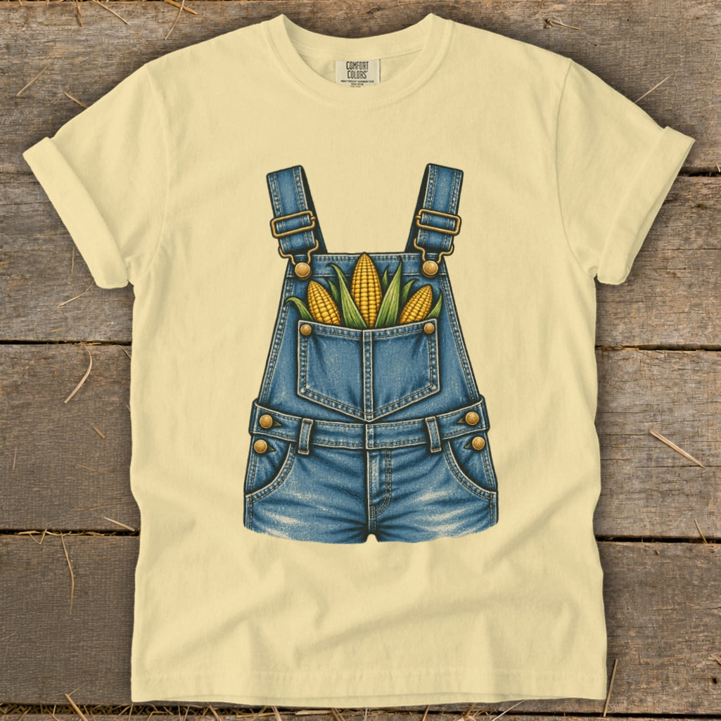 Light yellow t-shirt with denim overalls graphic filled with corn ears.