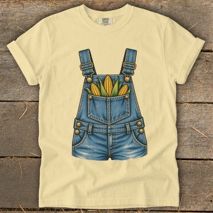 Light yellow t-shirt with denim overalls graphic filled with corn ears.
