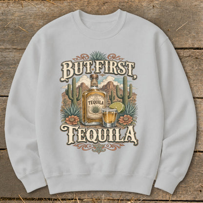 Gray sweatshirt with a "But First, Tequila" graphic featuring a tequila bottle, shot, and desert landscape.