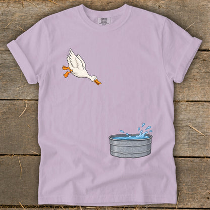 Cartoon duck jumps into a splashing galvanized water tub.