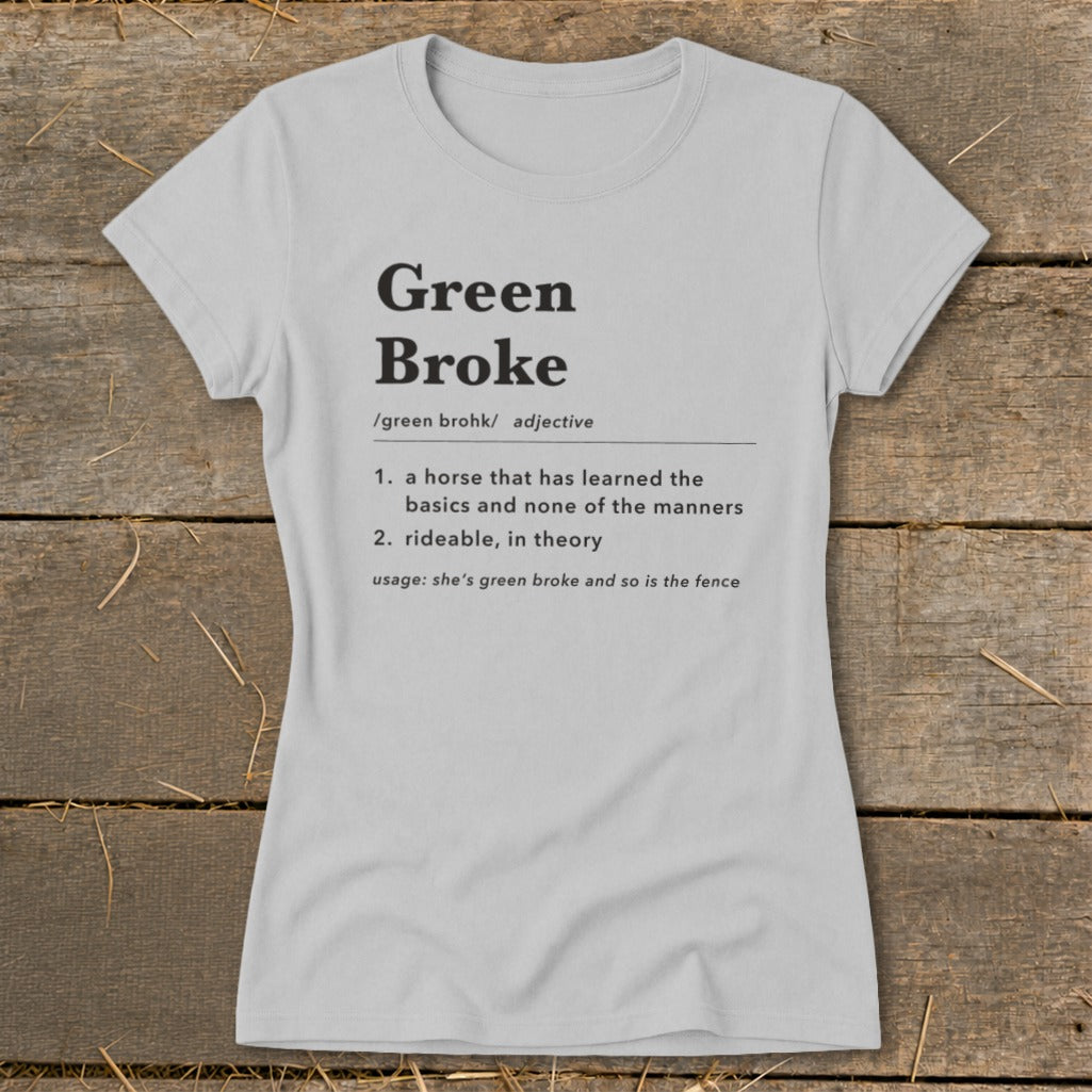 Light grey women's t-shirt printed with a dictionary definition of Green Broke laid on wooden planks.