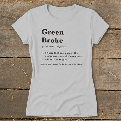 Light grey women's t-shirt printed with a dictionary definition of Green Broke laid on wooden planks.