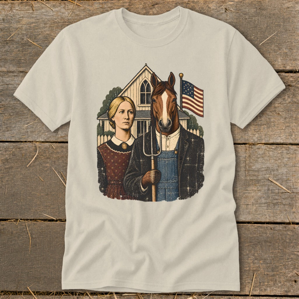Beige t-shirt featuring a satirical American Gothic parody graphic of a woman and a horse-headed man holding a pitchfork.