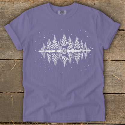 Purple t-shirt with white forest scene, deer, and reflection.