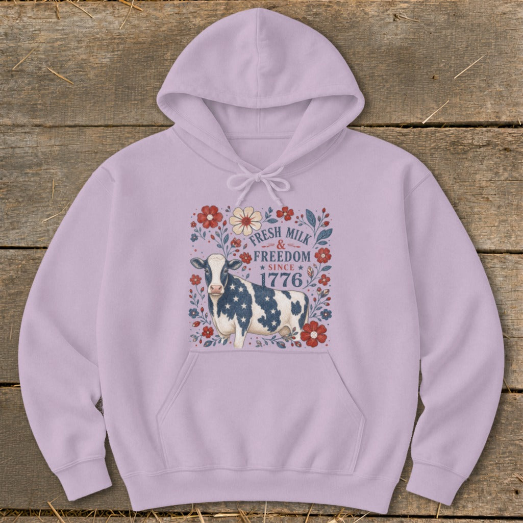Cow with stars and stripes pattern and floral border reads "Fresh Milk & Freedom Since 1776".