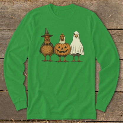 Three chickens dressed for Halloween: witch, pumpkin, and ghost costumes.