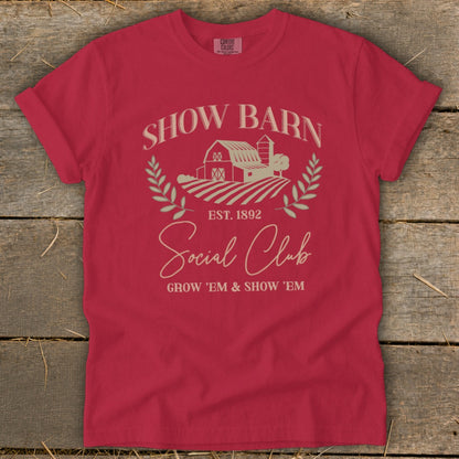 Red t-shirt with "Show Barn Social Club" graphic, including a barn and fields.