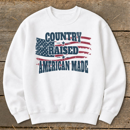 White sweatshirt with "Country Raised American Made" graphic and American flag design.