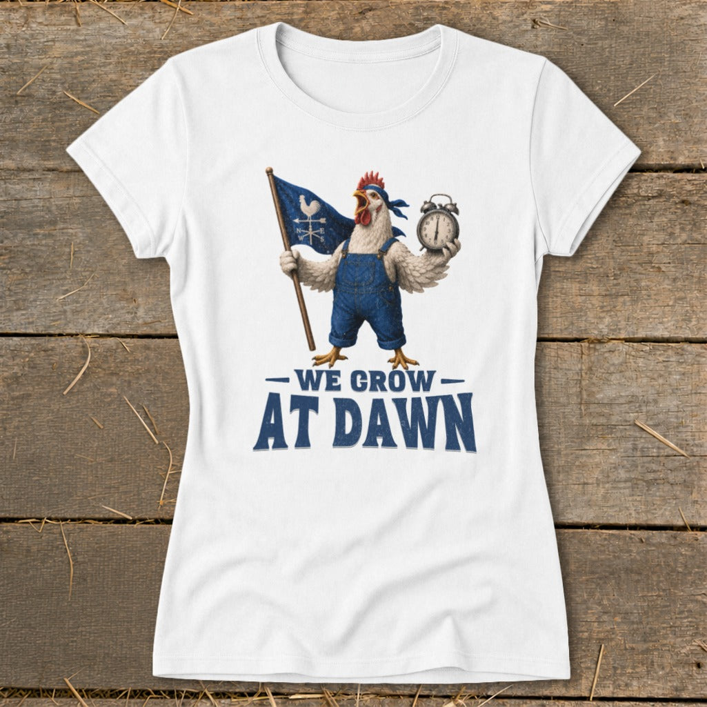 White t-shirt with chicken in overalls holding flag and alarm clock, text "We Grow At Dawn".