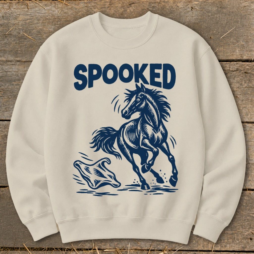 Cream sweatshirt with "SPOOKED" text above a spooked horse and ghost graphic.