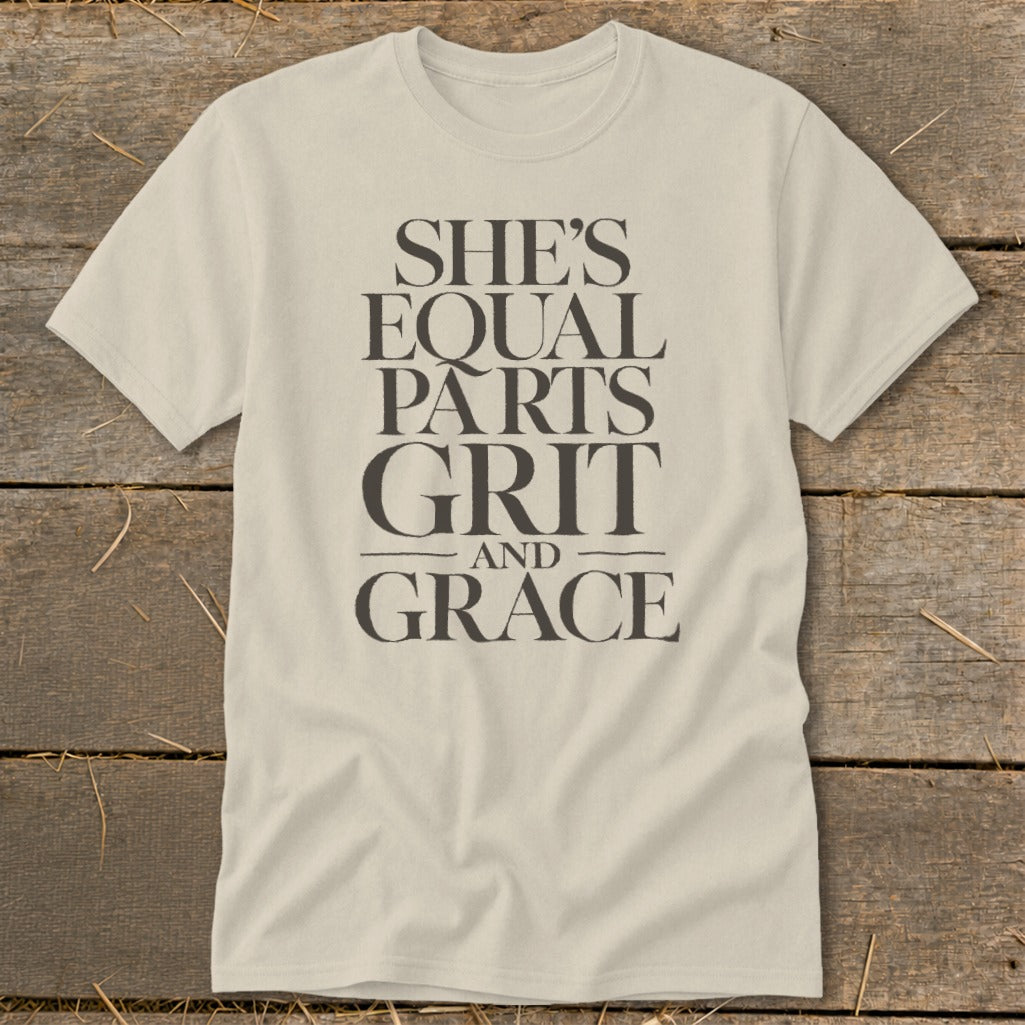 Cream t-shirt with "She's Equal Parts Grit and Grace" text.