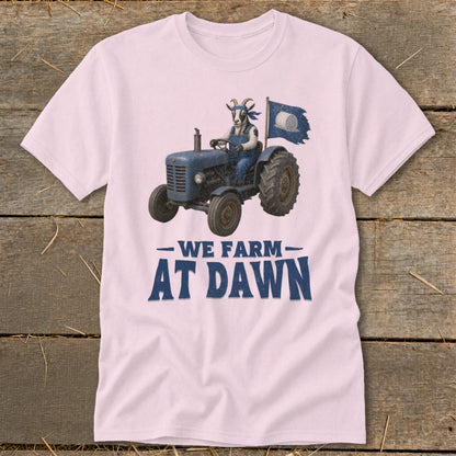 Goat in overalls driving tractor with flag, "WE FARM AT DAWN" text.