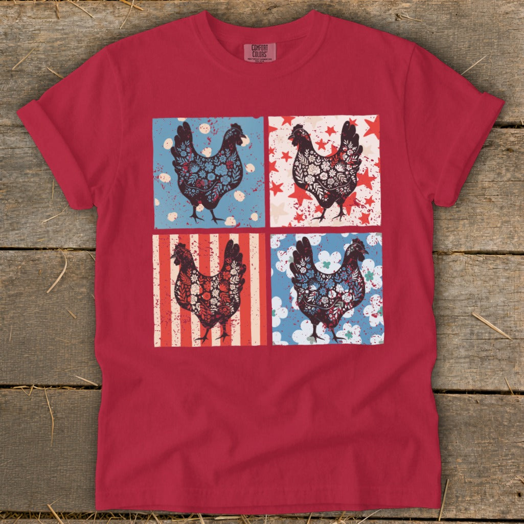 Red t-shirt with four square panels featuring floral and patriotic chickens.