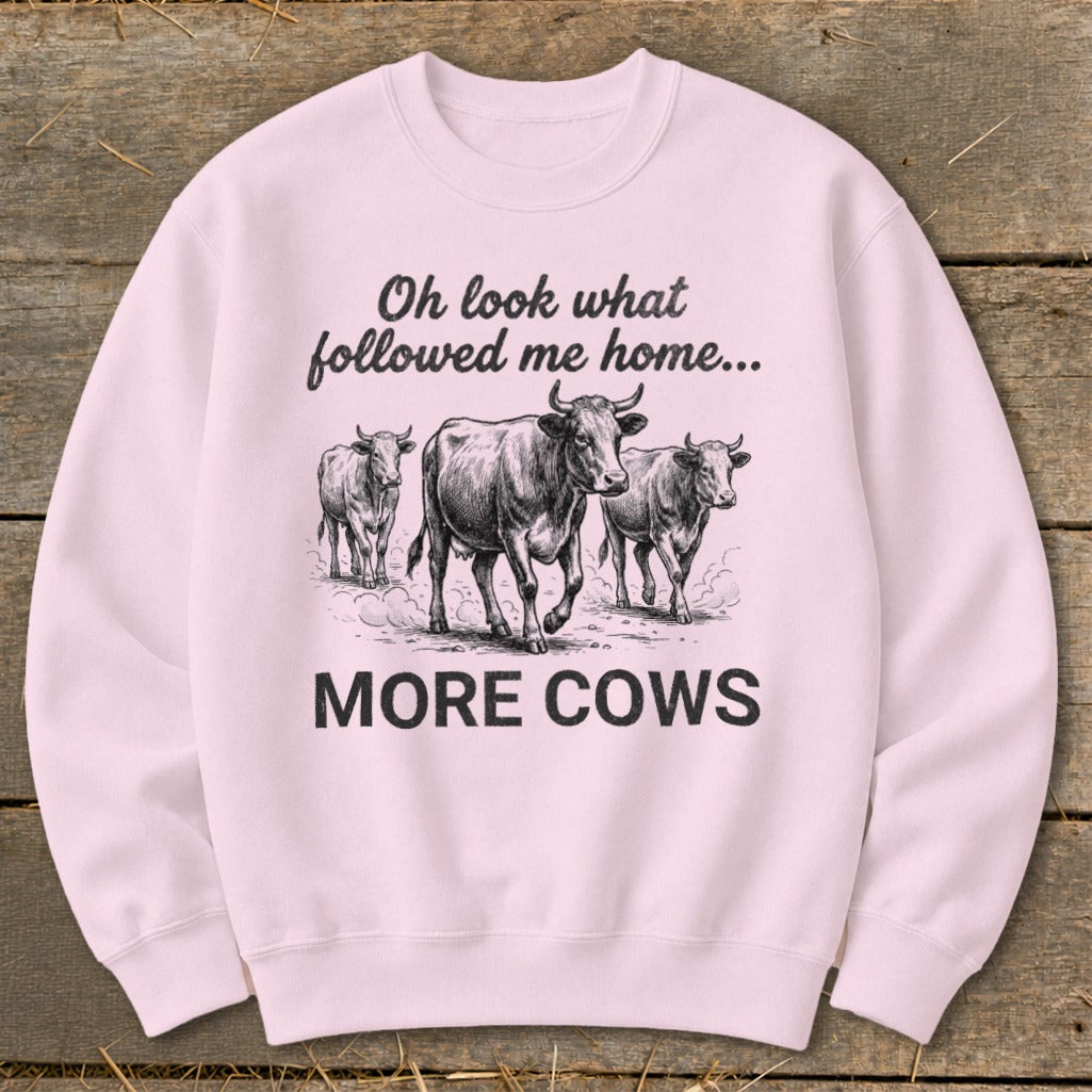 Pink sweatshirt with sketch of three cows and text "Oh look what followed me home... MORE COWS".