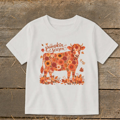 White t-shirt with a floral cow and "pumpkin season" text.