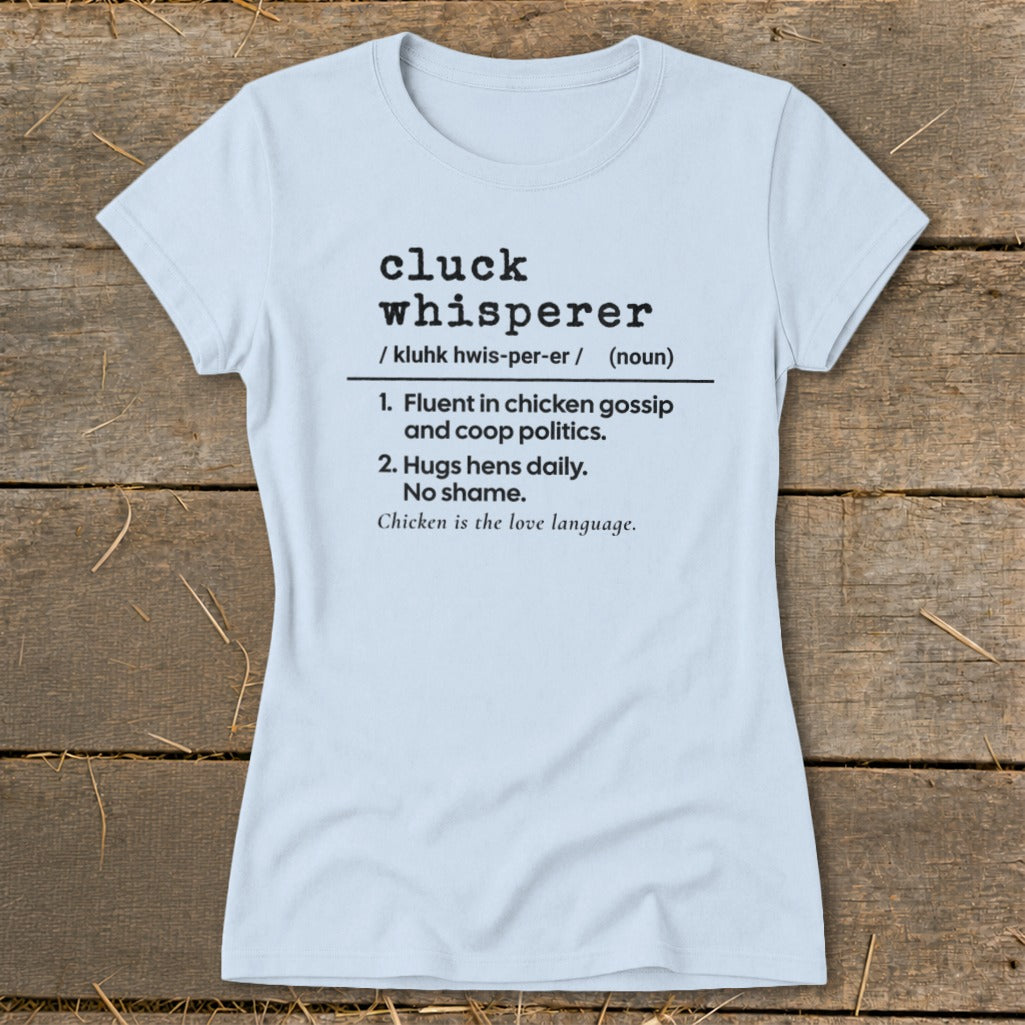 Light blue t-shirt with "Cluck Whisperer" definition and chicken humor.