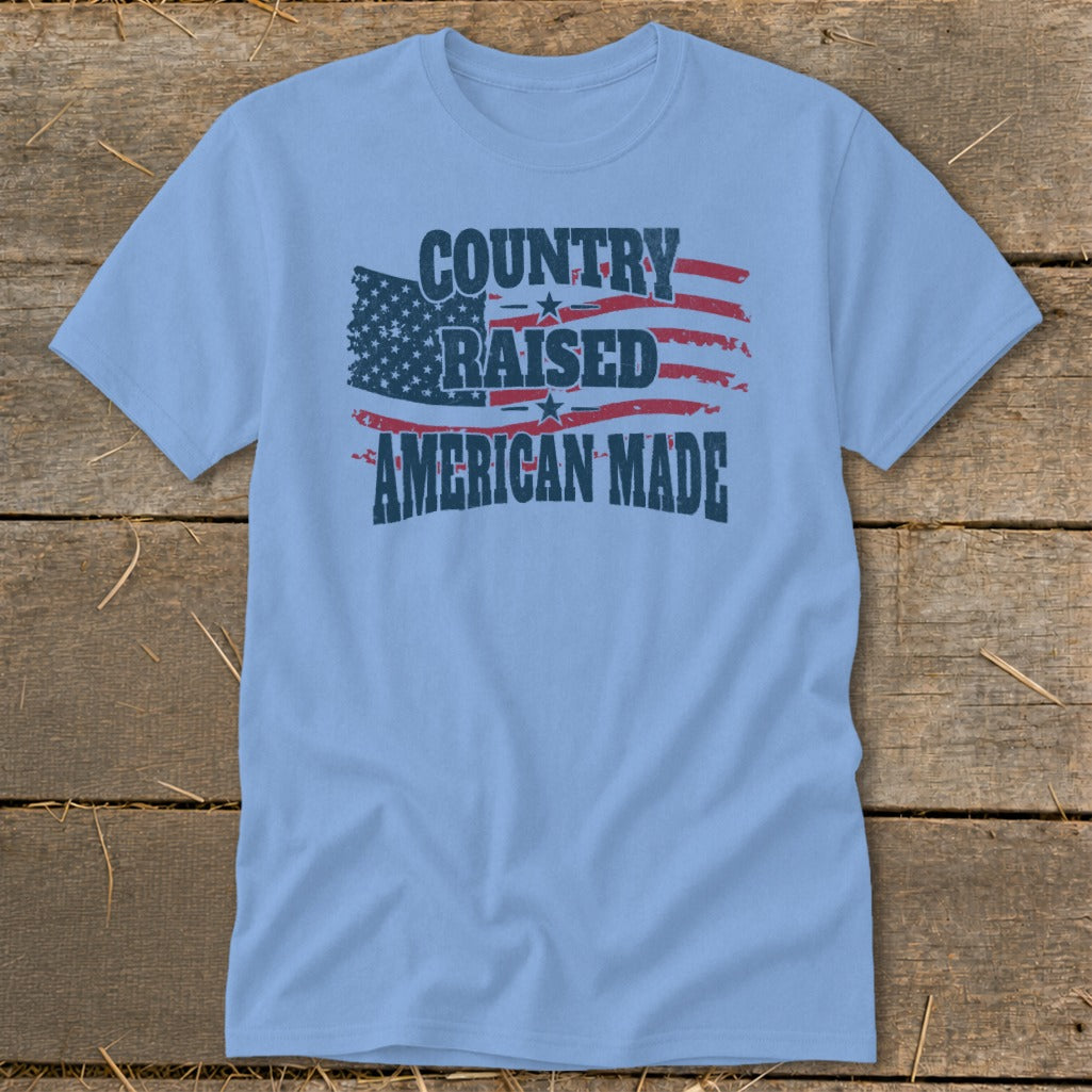 Light blue t-shirt with distressed American flag graphic and text: Country Raised American Made.